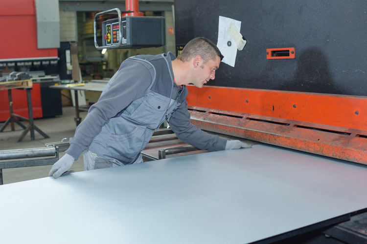 man holding metal plate